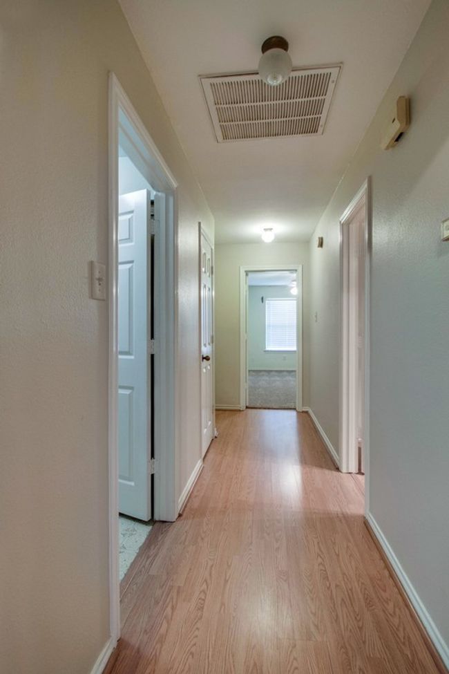 Hallway with light wood-style floors and baseboards | Image 7