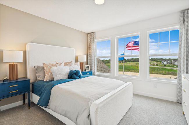 Photo is of the actual model. The second generously sized upper level secondary bedroom with a spacious closet. | Image 19