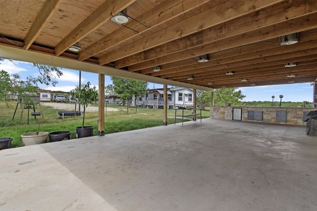 The centerpiece is a spacious 2, 061 sq ft manufactured home, just 1.5 years old, with 4 bedrooms, 2 bathrooms, and a beautifully crafted 40' x 20' stone outdoor kitchen under a covered roof with lighting—ideal for hosting under the stars. | Image 16