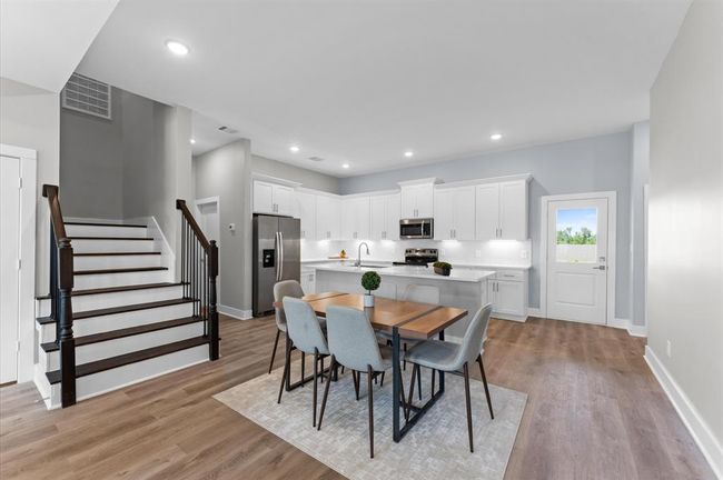 Dining area filled with natural light and open to the kitchen and living room | Image 11