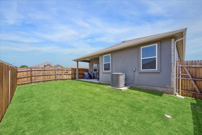 Rear view of house featuring stucco siding and a fenced backyard | Image 37
