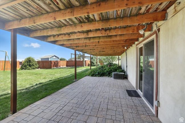 Fenced backyard featuring a patio area | Image 30