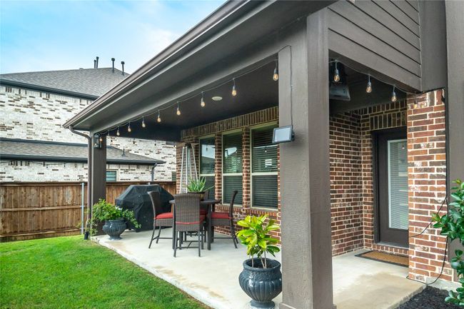 View of patio featuring fence and a grill | Image 33