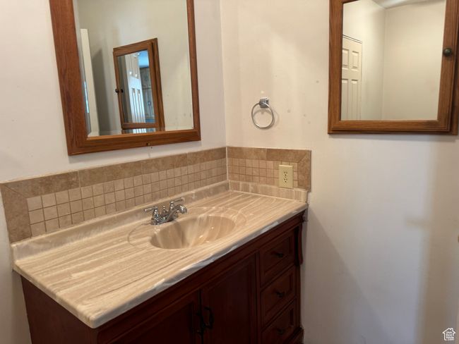 Bathroom with vanity and decorative backsplash | Image 24