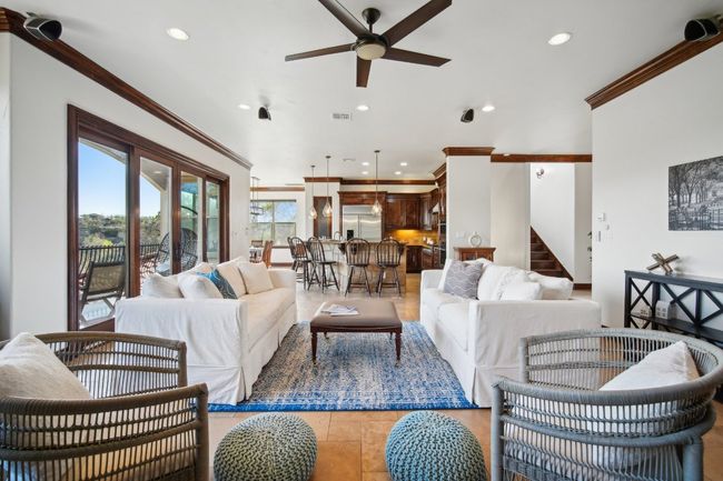 Living room with visible vents, stairs, ornamental molding, recessed lighting, and a ceiling fan | Image 10