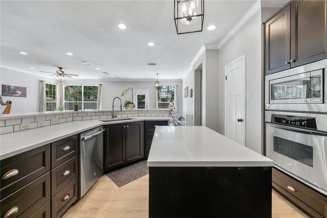 Preparing festive meals will be a breeze with the high-quality stainless-steel appliances which include an electric cooktop with a vented range hood. | Image 9