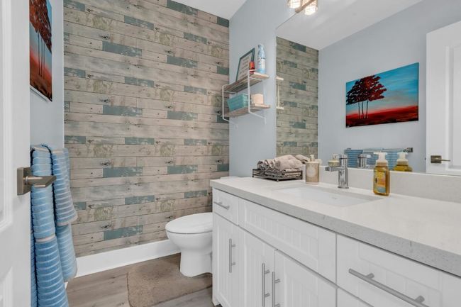 Bathroom with vanity, wooden walls, toilet, and walk in shower | Image 16