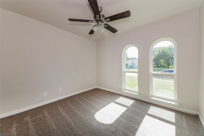 Carpeted spare room featuring ceiling fan and baseboards | Image 23