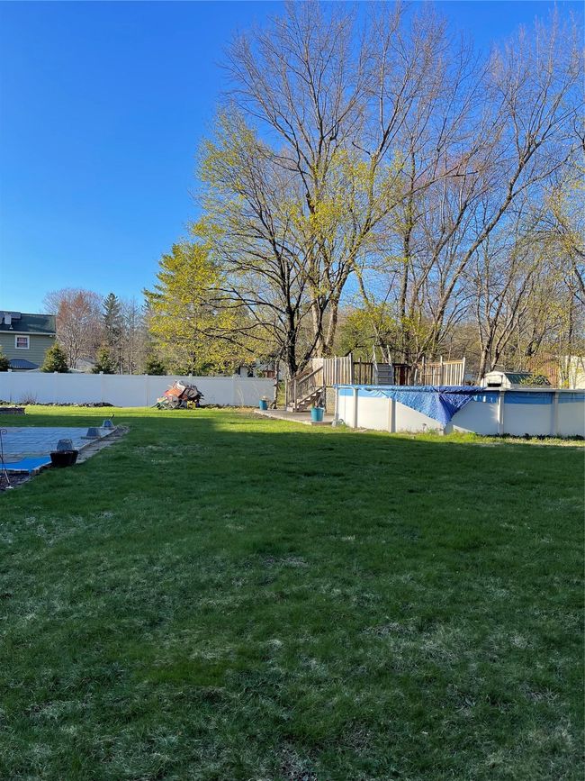 View of yard with an above ground pool | Image 14
