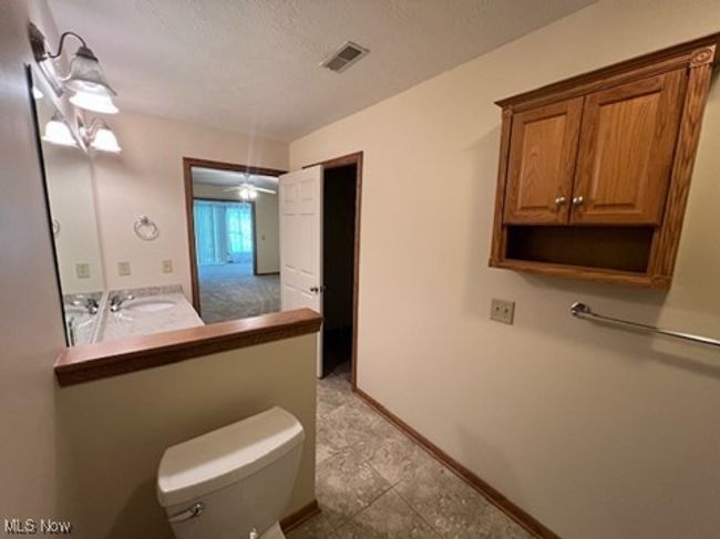 Bathroom with toilet and a textured ceiling | Image 16