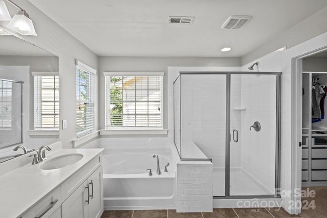 Primary bathroom features double vanity, oversized shower, soaking bathtub & walk-in closet. | Image 19