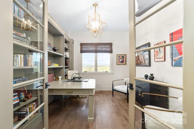 Let the views inspire you in the office/creative studio with custom bookcase and desk on the main level. | Image 13
