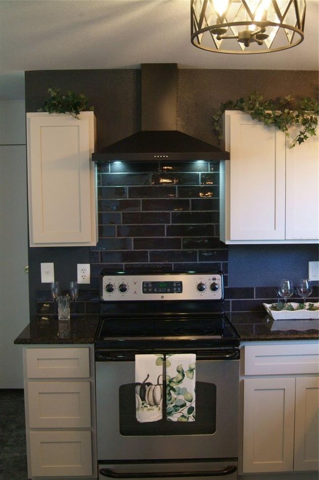 Stove with Modern Bkack Brick Tile Backsplash and custom vent hood | Image 6