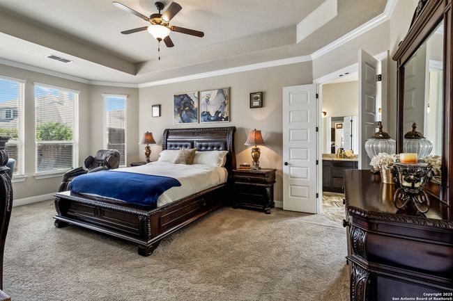 Luxurious primary bedroom offering a spacious retr | Image 22
