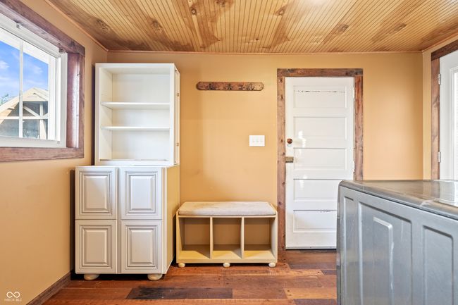 doorway featuring wood finished floors, washer / clothes dryer, and wood ceiling | Image 47