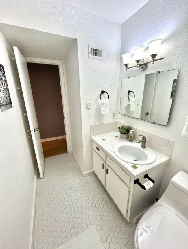 Half bathroom with vanity and a textured wall | Image 16