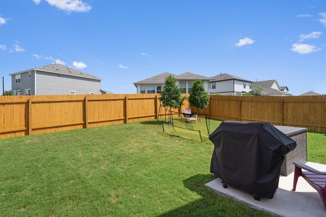 Fenced backyard with a residential view | Image 25