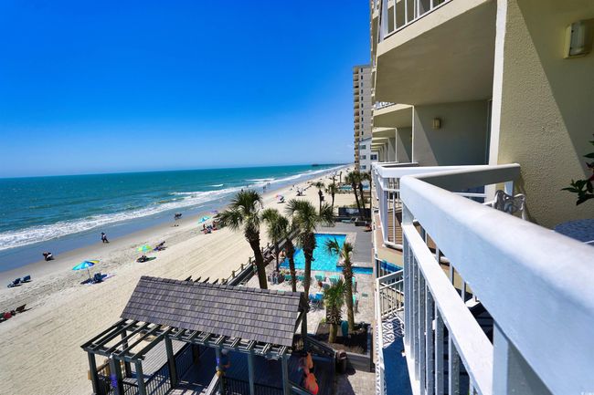 Balcony with view of water and beach and view of pool area | Image 31