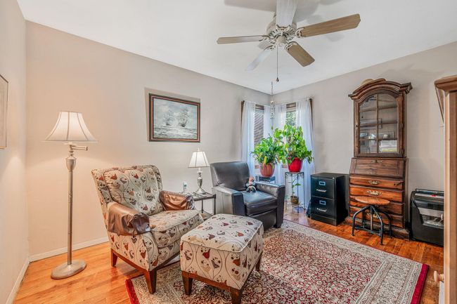 Living area with wood finished floors and ceiling fan | Image 12