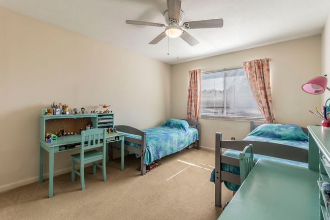 Bedroom featuring carpet, ceiling fan, and baseboards | Image 25