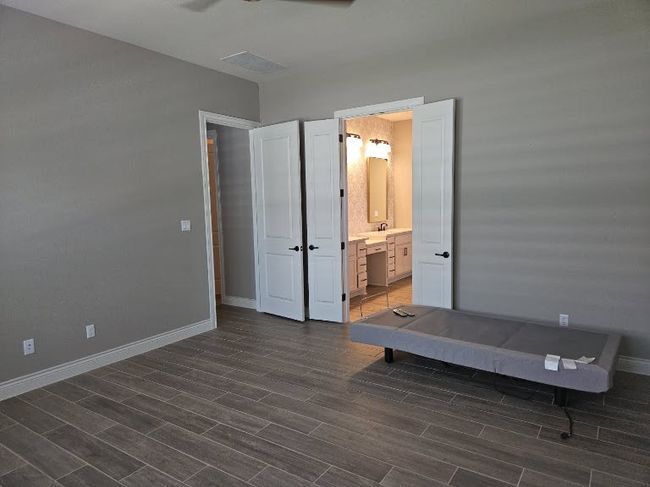 Bedroom featuring dark wood-type flooring, ensuite bath, and ceiling fan | Image 18