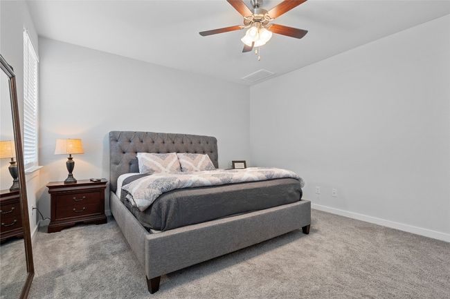 Bedroom with carpet, baseboards, and ceiling fan | Image 20
