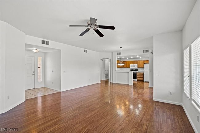Resort-Style First Floor Living in Prime Summerlin South! Located in a highly sought-after gated Garden Terrace community, complete with a spacious 2-car tandem garage. Step inside to an expansive open-concept living space filled with warm natural light and designer touches throughout. Featuring a brand-new air conditioning system and a recently upgraded water heater, this turnkey residence is move-in ready and designed for effortless living. | Image 11