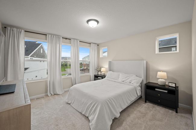 Primary bedroom upper level, with the house being an end unit you will have the pleasure of more natural sunlight coming into the room from the two additional windows | Image 15