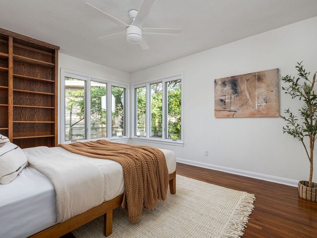 Bedroom featuring wood flooring and a ceiling fan | Image 20