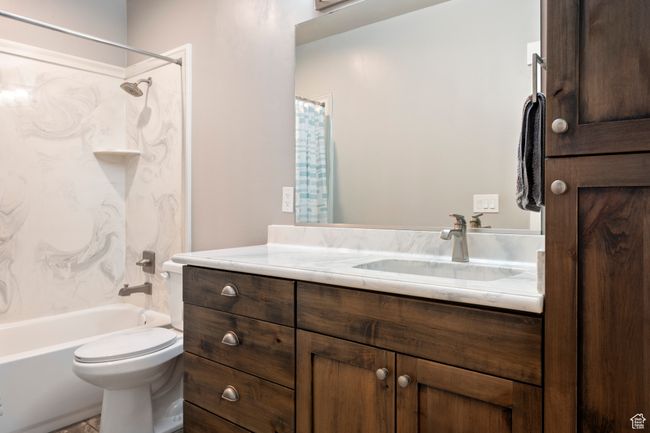 Bathroom featuring shower / tub combo, toilet, and vanity | Image 33