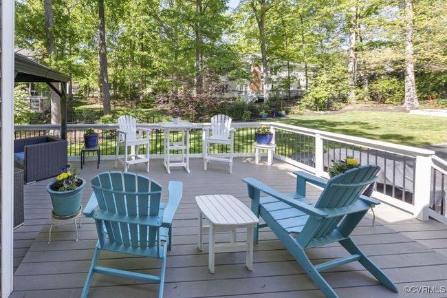 Deck with a lawn and view of scattered trees | Image 42