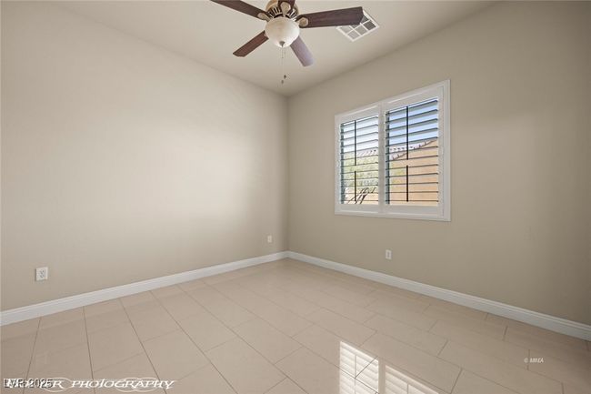 Spare room featuring ceiling fan, baseboards, and visible vents | Image 34