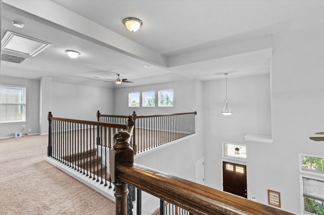 Corridor featuring carpet floors, attic access, an upstairs landing, and baseboards | Image 19