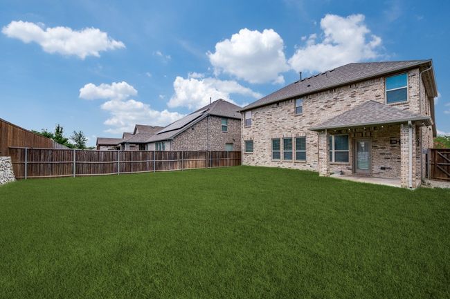 Fenced backyard with a patio | Image 12