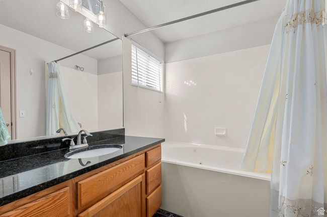 Full bathroom featuring vanity and shower / jetted tub combo | Image 15