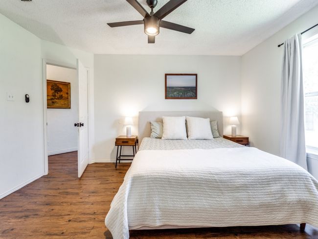 Bedroom featuring wood finished floors, a textured ceiling, and ceiling fan | Image 19