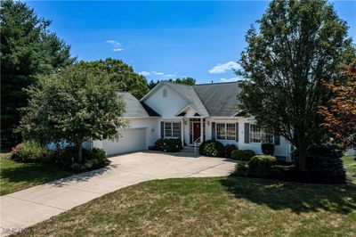 View of front of house featuring a front yard and a garage | Image 1