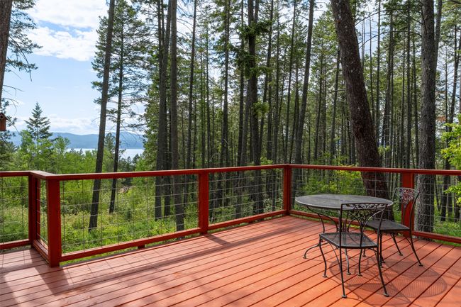 Wooden deck with a mountain view and outdoor dining area | Image 73