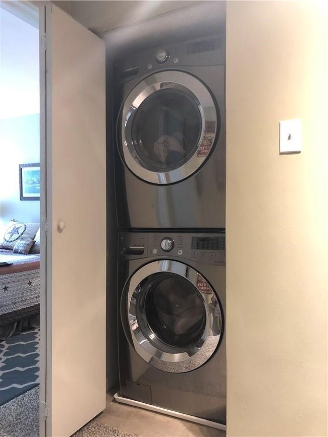 Washroom with stacked washing machine and dryer | Image 12
