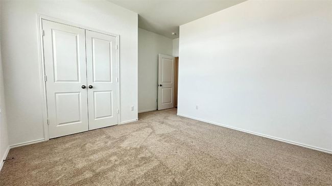 Unfurnished bedroom with a closet, carpet, and baseboards | Image 10