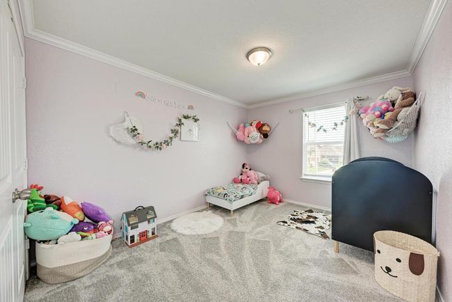 Carpeted bedroom with ornamental molding and baseboards | Image 29