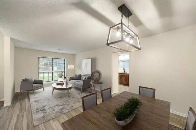 Large windows fill the living and dining area with abundant natural light, highlighting the spacious layout and stylish neutral flooring. This photo has been virtually staged. | Image 9