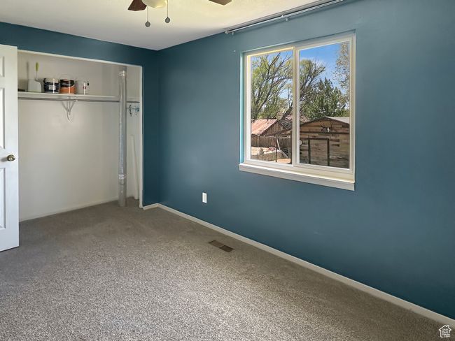 Unfurnished bedroom featuring a closet, carpet floors, baseboards, and a ceiling fan | Image 17