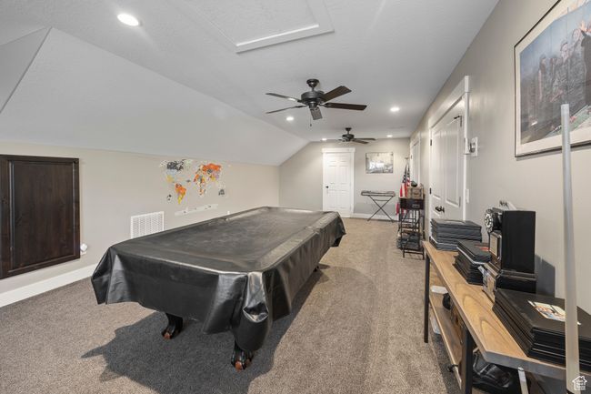 Game room featuring light carpet, billiards table, ceiling fan, baseboards, and vaulted ceiling | Image 59
