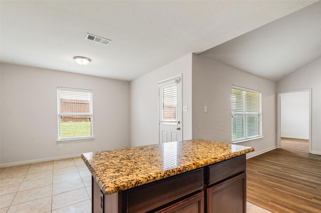 Kitchen with healthy amount of natural light, baseboards, and light stone counters | Image 10