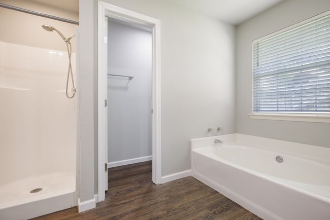 Bathroom with wood finished floors, a bath, and a shower | Image 15