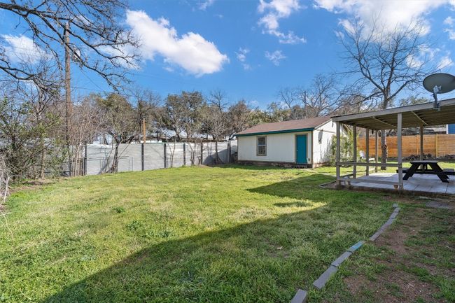 View of yard featuring a patio, an outdoor structure, and a fenced backyard | Image 5