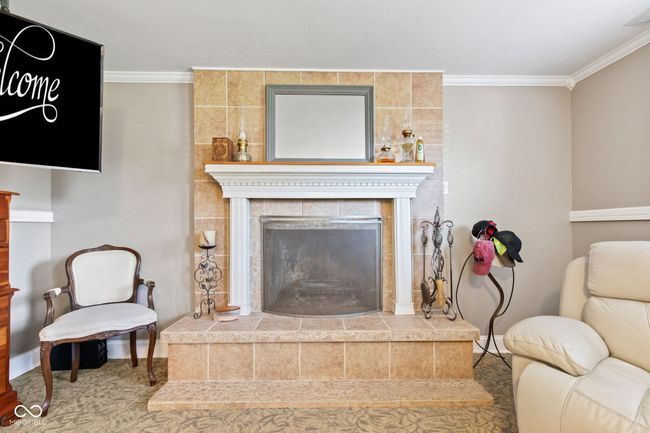 Currently used as a second primary bedroom. This spaces area has crown molding and a fireplace | Image 45