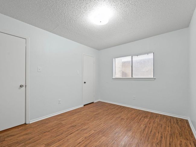 Unfurnished room with wood finished floors and a textured ceiling | Image 13