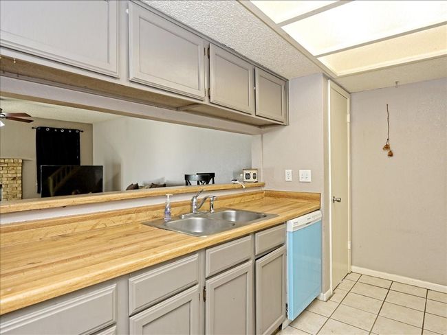 Not actual unit, similar layout. Kitchen overlooking living area. | Image 7